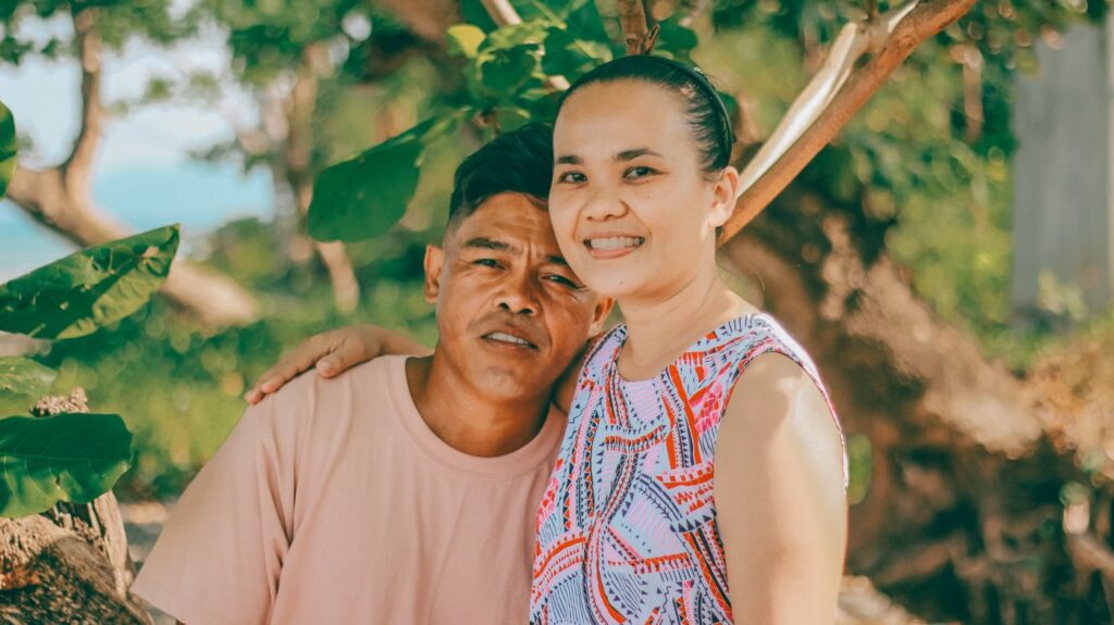 Smiling couple posing together outdoors