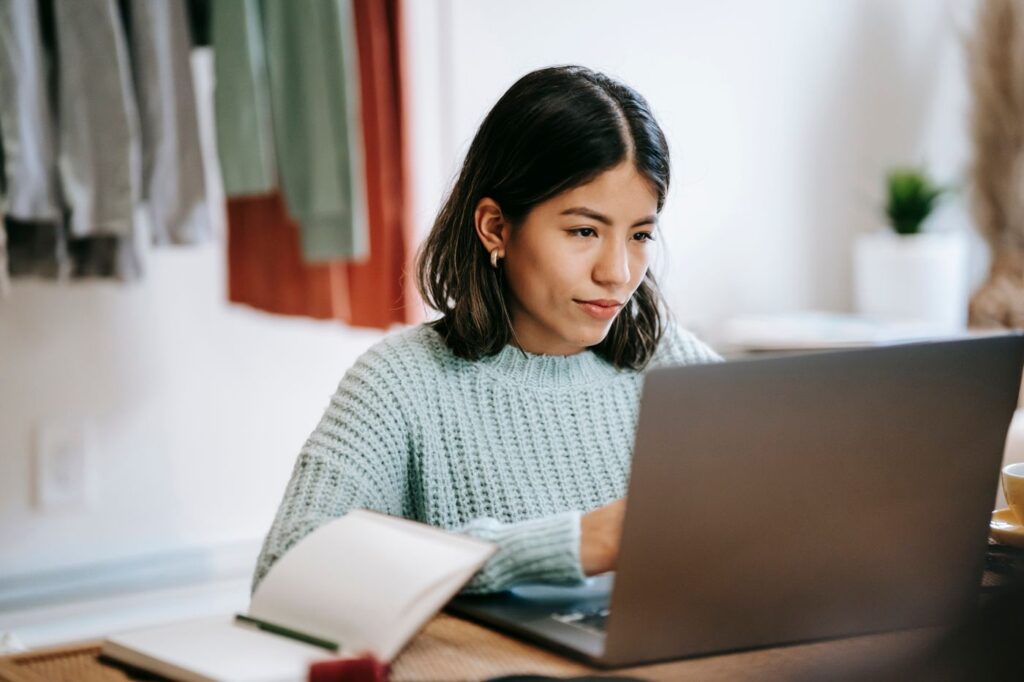 Young woman working on a laptop at home