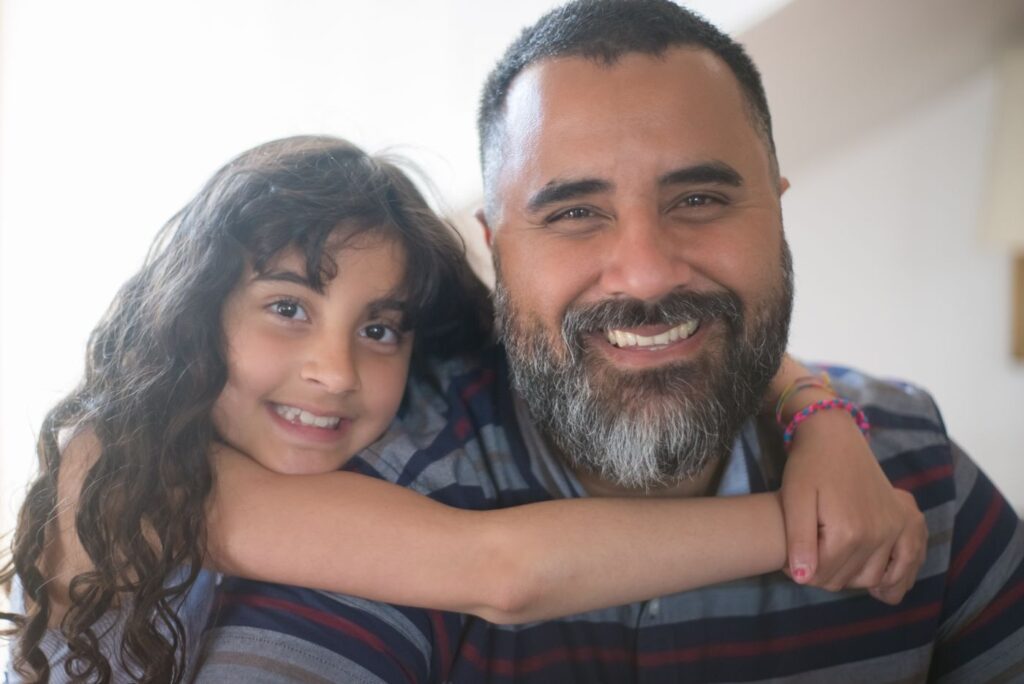 Father and daughter smiling and hugging