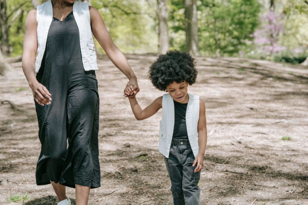 Mother and child walking hand in hand outdoors